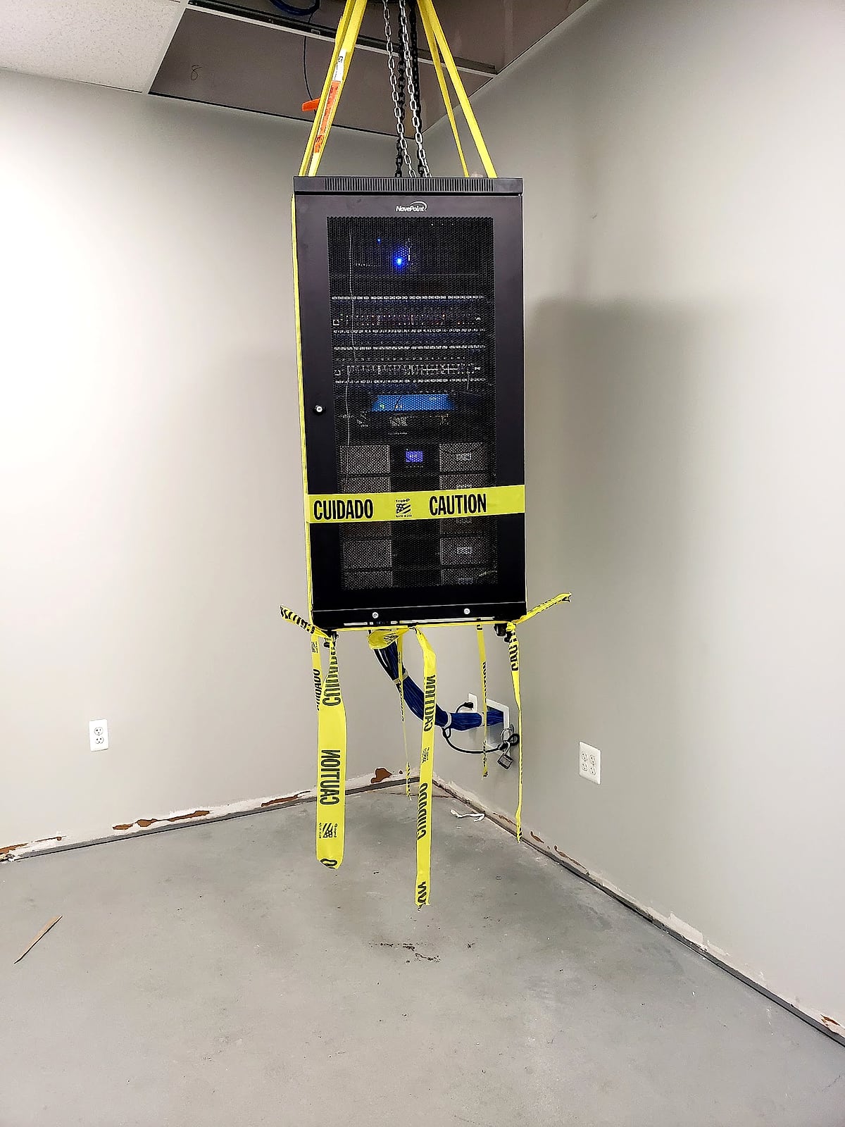 Network rack safely suspended from a temporary hoist while the floor is refinished.