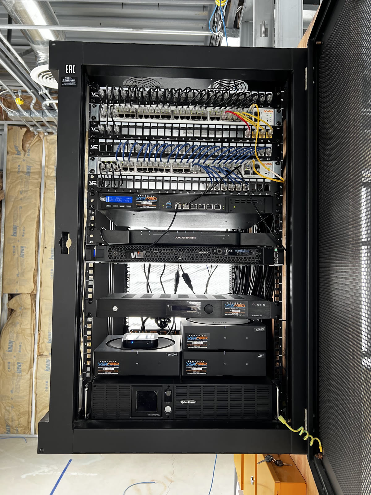 Large commercial network rack with organized equipment and patching.